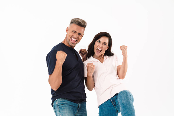 Cheerful couple wearing casual outfit standing isolated - Foto, Bild
