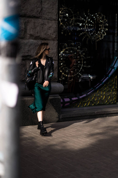 Young beautiful woman walks around the city in Europe, street photo, female posing in the city center - Valokuva, kuva