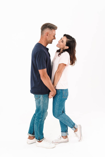 Cheerful happy adult loving couple isolated over white wall background. - Fotoğraf, Görsel
