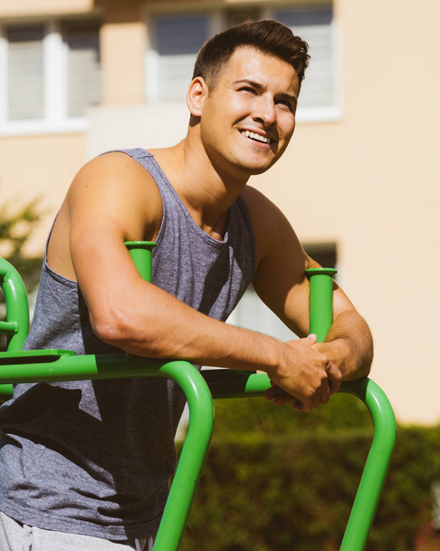 Happy man relaxing after outdoor workout - Photo, Image