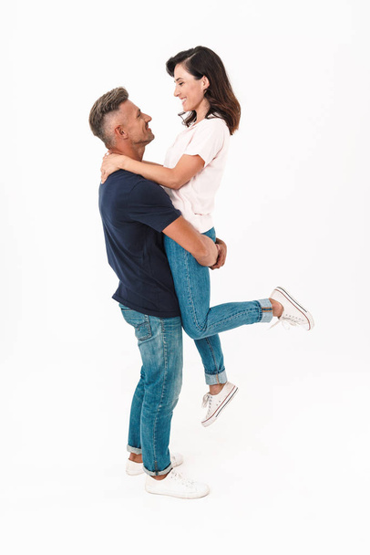 Positive adult loving couple isolated over white wall background having fun. - Fotoğraf, Görsel