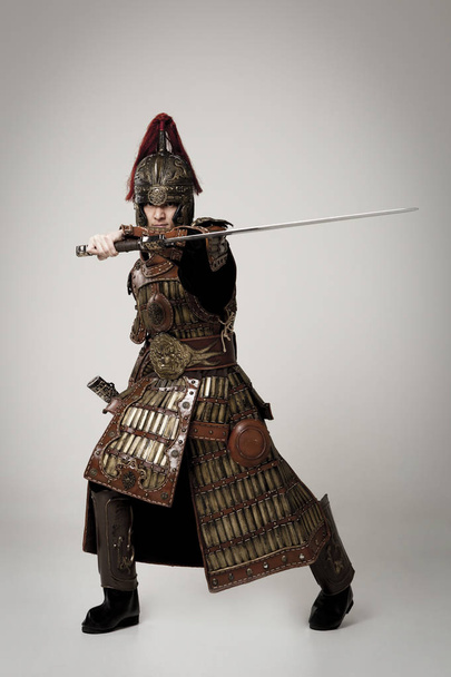 Adult male wearing very old armor. - 写真・画像