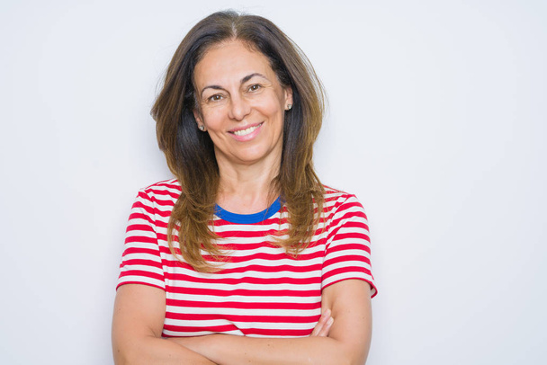 Middle age senior woman standing over white isolated background happy face smiling with crossed arms looking at the camera. Positive person. - Photo, Image