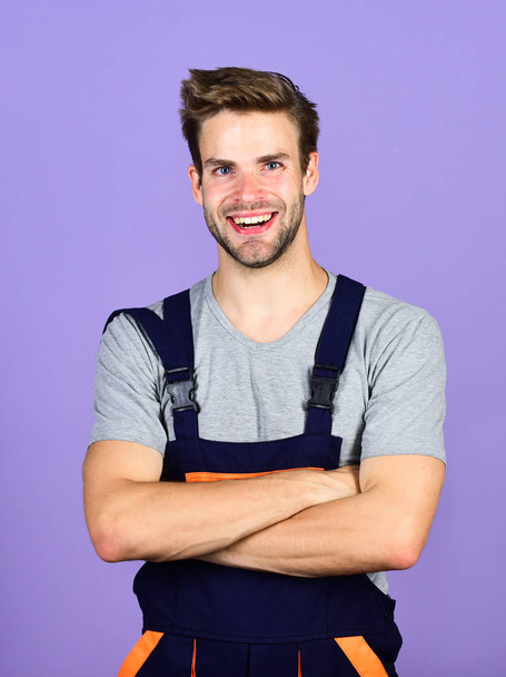 Confident worker. professional repairman. turnkey project. man build house. skilled architect repair and fix. worker purple background. building skills and construction. man builder in work clothes - Foto, imagen