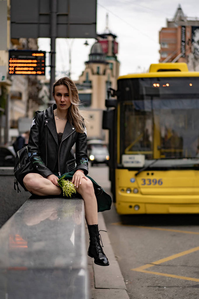 Young beautiful woman walks around the city in Europe, street photo, female posing in the city center - 写真・画像