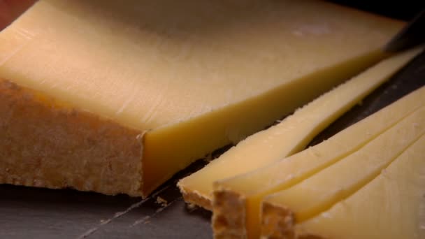 Hard goat cheese is cut into thin slices - Imágenes, Vídeo