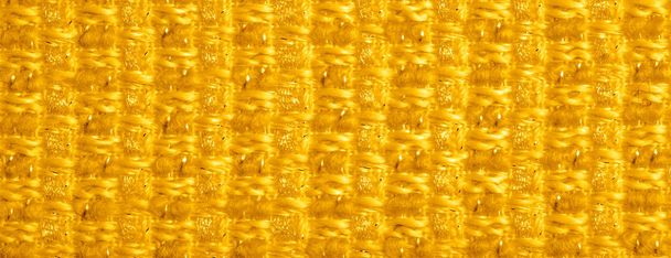 Tekstura tła, wzór. Żółta tkanina z metalowymi cekinami - Zdjęcie, obraz