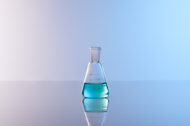 glass flask with blue colorful liquid - Φωτογραφία, εικόνα