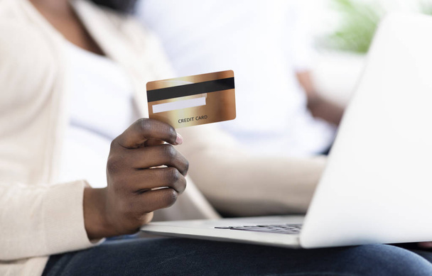 Mujer negra haciendo compras en línea con tarjeta de crédito y portátil
 - Foto, imagen