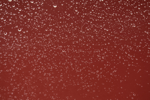 clear transparent water drops on red background - Foto, Imagen