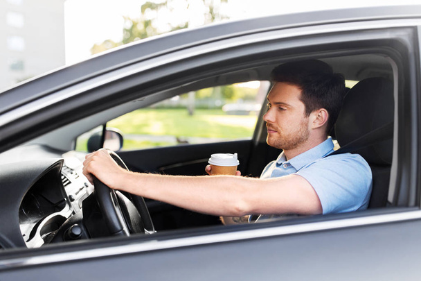 tired man driving car with takeaway coffee - Foto, Imagem