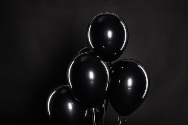 bunch of black balloons isolated on balck, black Friday concept - Фото, зображення