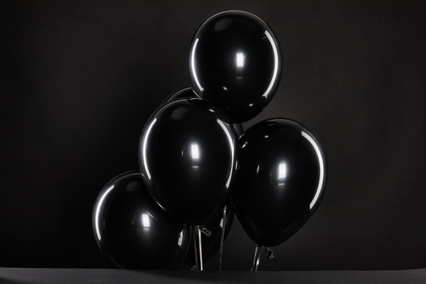 bunch of black balloons isolated on black, black Friday concept - Foto, Imagen