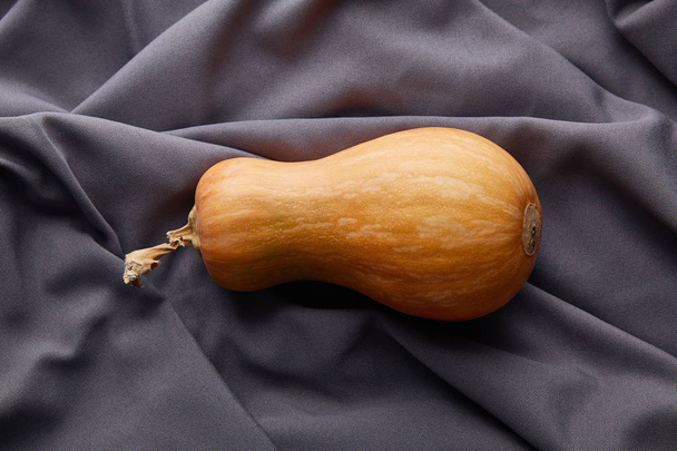 top view of ripe whole pumpkin on grey cloth - Photo, Image