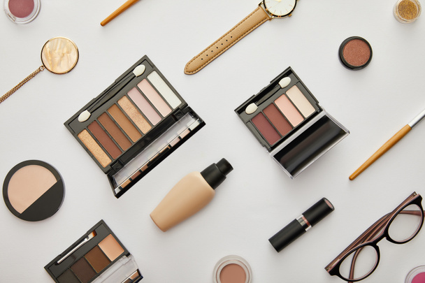 top view of face foundation near eye shadow and accessories isolated on grey  - Fotografie, Obrázek