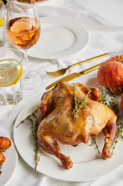grilled turkey near glasses with white wine and lemon water on white tablecloth - Фото, изображение