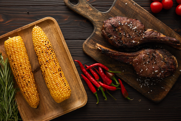 top view of meat, corn, chili peppers, cherry tomatoes, greenery - Photo, Image