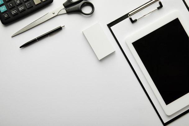 top view of clipboard, pen, business card, scissors, calculator and digital tablet  - Photo, Image