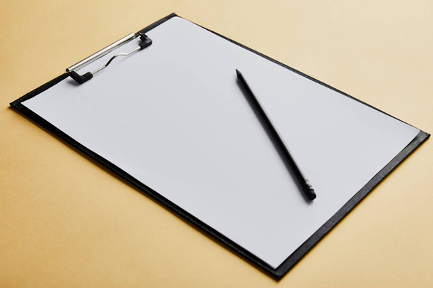 clipboard with copy space and pencil on yellow background  - Photo, Image