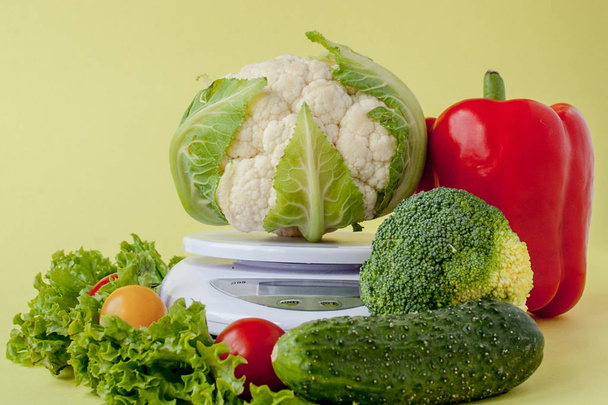Fresh vegetables on vase on yellow background. Healthy eating, diet planning, weight loss, detox, organic farming concept - Φωτογραφία, εικόνα