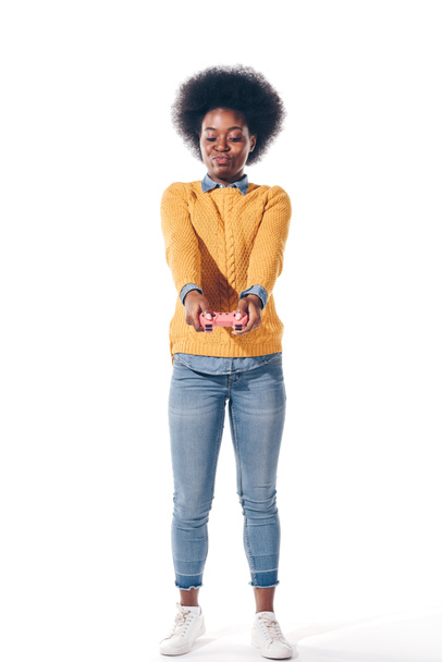 beautiful african american girl holding pink joystick, isolated on white - 写真・画像