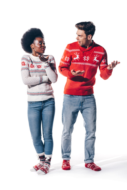 beautiful multiethnic couple in sweaters quarreling, isolated on white  - Valokuva, kuva