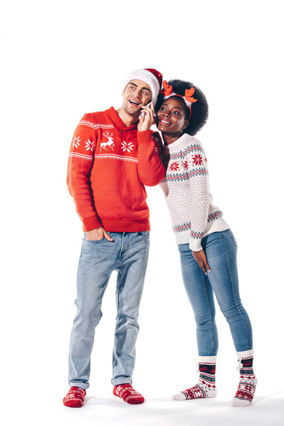 couple multiculturel en santa chapeau et cornes de cerf parler sur smartphone, isolé sur blanc
 - Photo, image