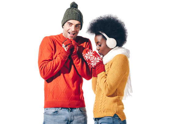 cold smiling multiethnic couple in winter clothes, isolated on white  - Valokuva, kuva