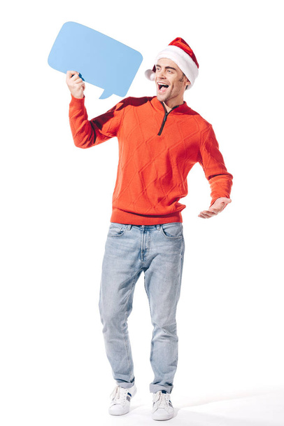 excited man in santa hat holding blue empty thought bubble, isolated on white - Photo, image