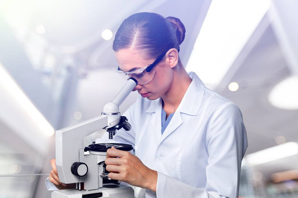 Young Female Scientist Working with Microscope   - Photo, Image
