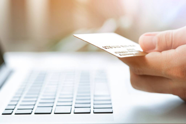 Man holding a credit card and typing - Photo, image