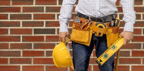 man with tool belt on background,close up - Photo, image