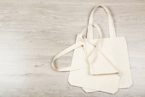 White cotton eco bags on wooden background - Zdjęcie, obraz