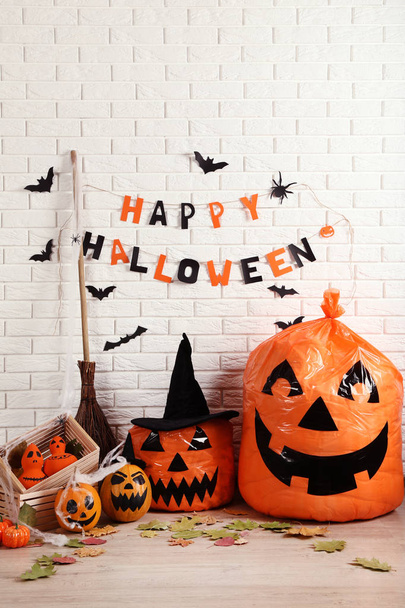 Halloween decorations with orange pumpkins, broom and paper bats - Foto, Imagen