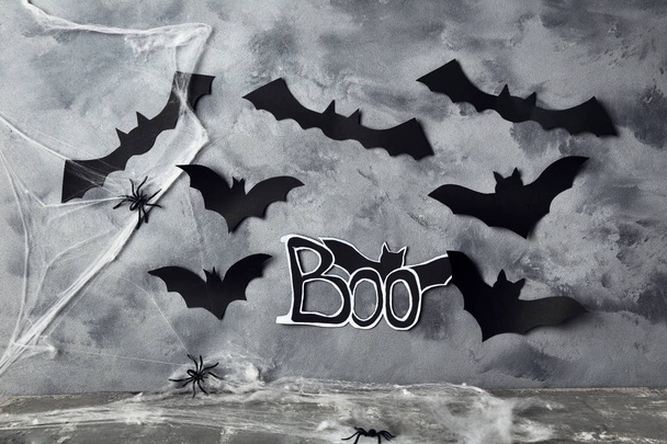 Paper halloween bats with spiders and spiderweb on grey backgrou - Fotó, kép