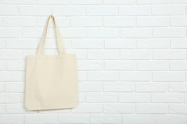 White cotton eco bag on brick wall background - Zdjęcie, obraz