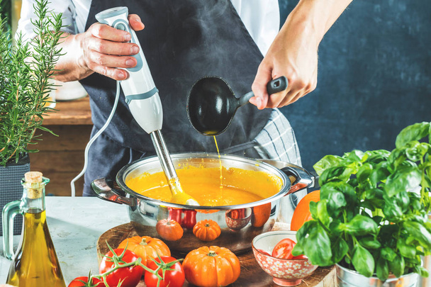 cropped shot of person preparing pumpkin soup puree with mixer - Zdjęcie, obraz