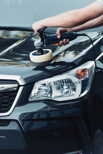 cropped view of car cleaner polishing car with polish machine - Foto, Imagem