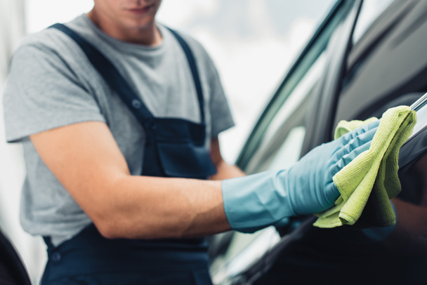 cropped view of car cleaner wiping car with rag - Photo, Image