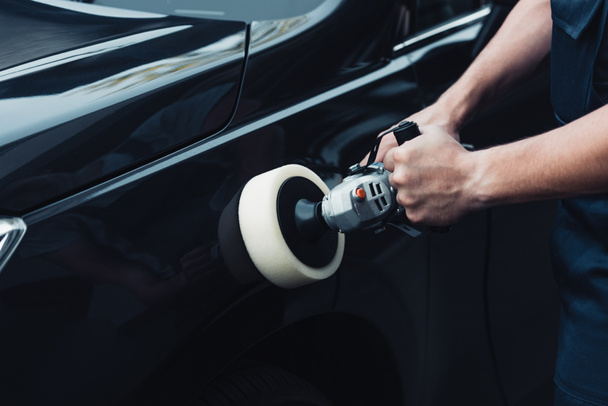 cropped view of car cleaner polishing black car with buffer machine - Photo, Image