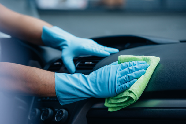 partial view of car cleaner vacuuming dashboard with rag - Valokuva, kuva