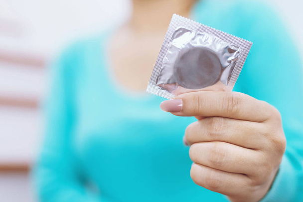 Kondom připravený k použití v mužské ruce, dát kondom bezpečné  - Fotografie, Obrázek