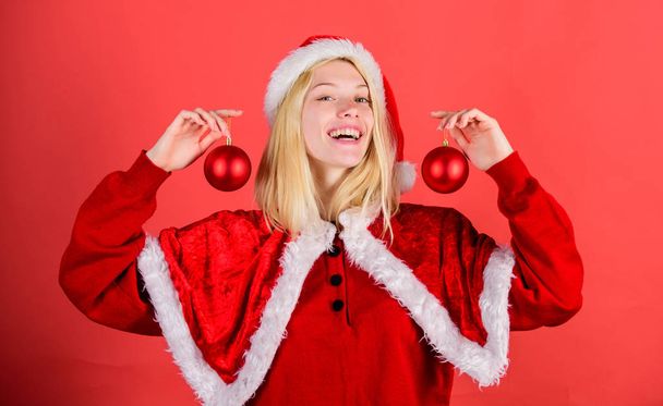 Favorite time year christmas. Merry christmas. Enjoy celebration with proper costume and decoration. Girl happy wear santa costume celebrate christmas hold ball decor. Happy holidays concept - Foto, imagen