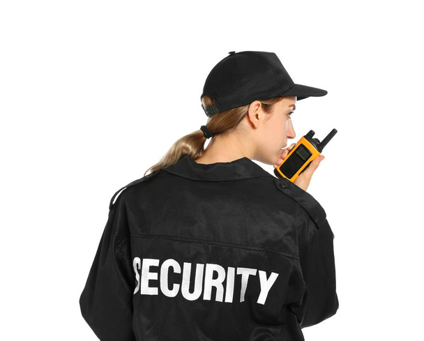 Female security guard in uniform using portable radio transmitter on white background - Φωτογραφία, εικόνα
