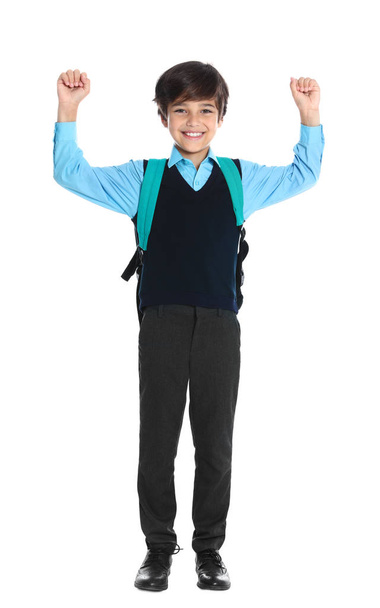 Niño feliz en uniforme escolar sobre fondo blanco
 - Foto, imagen
