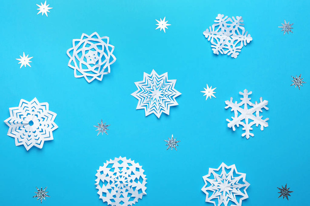 Flat lay composition with paper snowflakes on blue background. Winter season - Foto, immagini