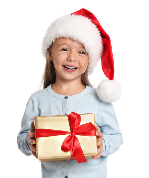 Happy little child in Santa hat with gift box on white background. Christmas celebration - Foto, afbeelding