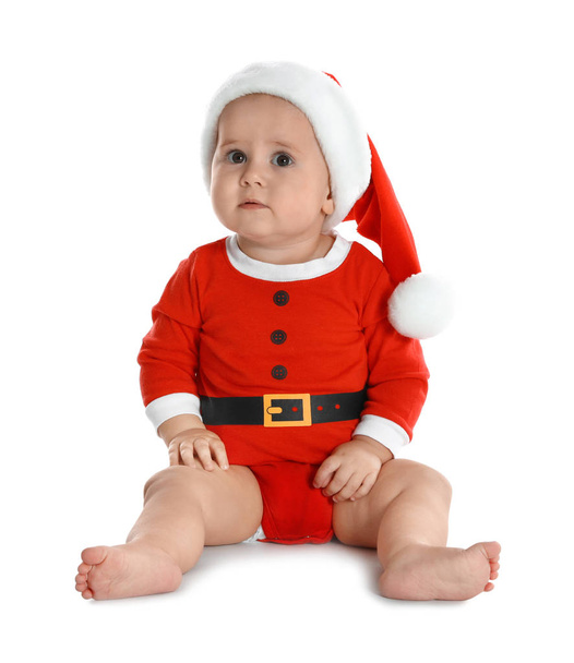 Cute little baby wearing festive Christmas costume on white background - Fotó, kép