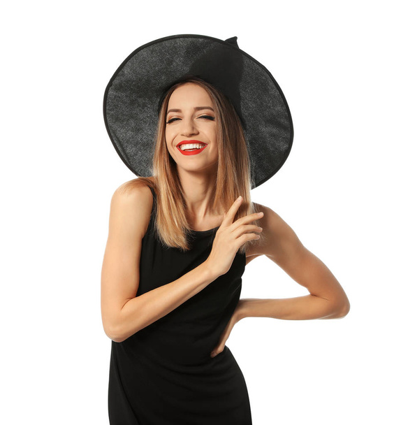 Beautiful young woman wearing witch costume for Halloween party on white background - Foto, imagen