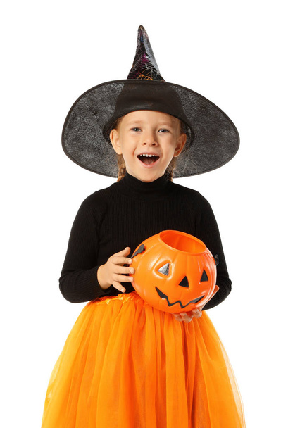 Cute little girl with pumpkin candy bucket wearing Halloween costume on white background - Foto, afbeelding